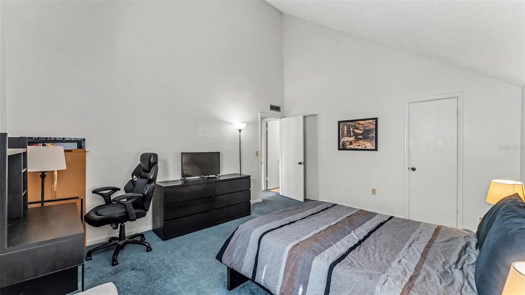 2025 Sylvester Road, Unit N305 Lakeland, FL 33803 - Photo 16 of 34 a bedroom with a bed and wooden floor