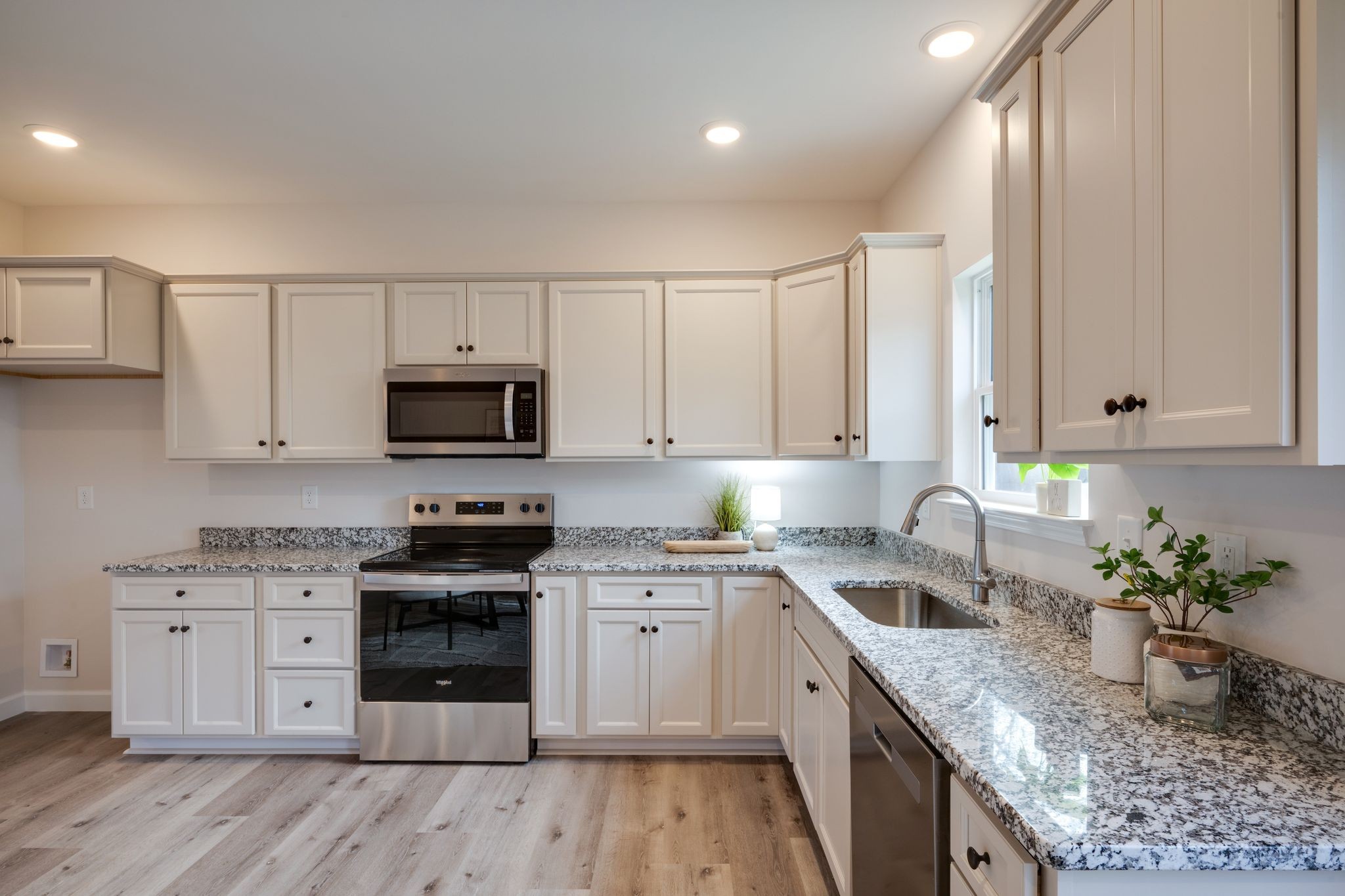 3033 Bowker Road Charlotte, TN 37036 - Photo 13 of 30 a kitchen with stainless steel appliances granite countertop a sink a stove and cabinets