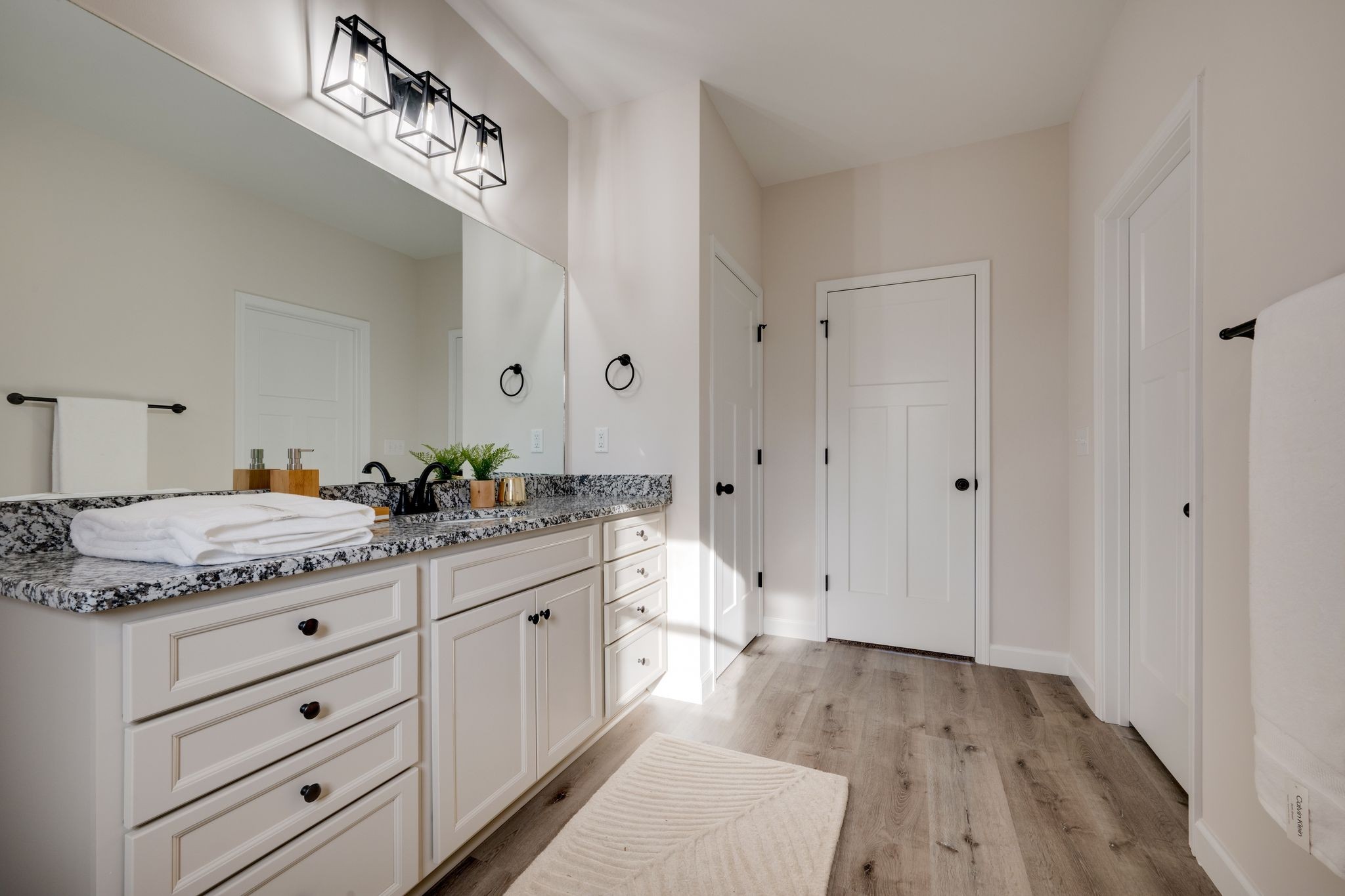 3033 Bowker Road Charlotte, TN 37036 - Photo 19 of 30 a spacious bathroom with a granite countertop sink a mirror and shower view