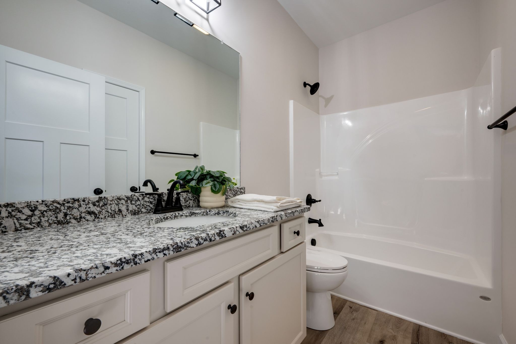 3033 Bowker Road Charlotte, TN 37036 - Photo 24 of 30 a bathroom with a granite countertop sink a toilet and shower