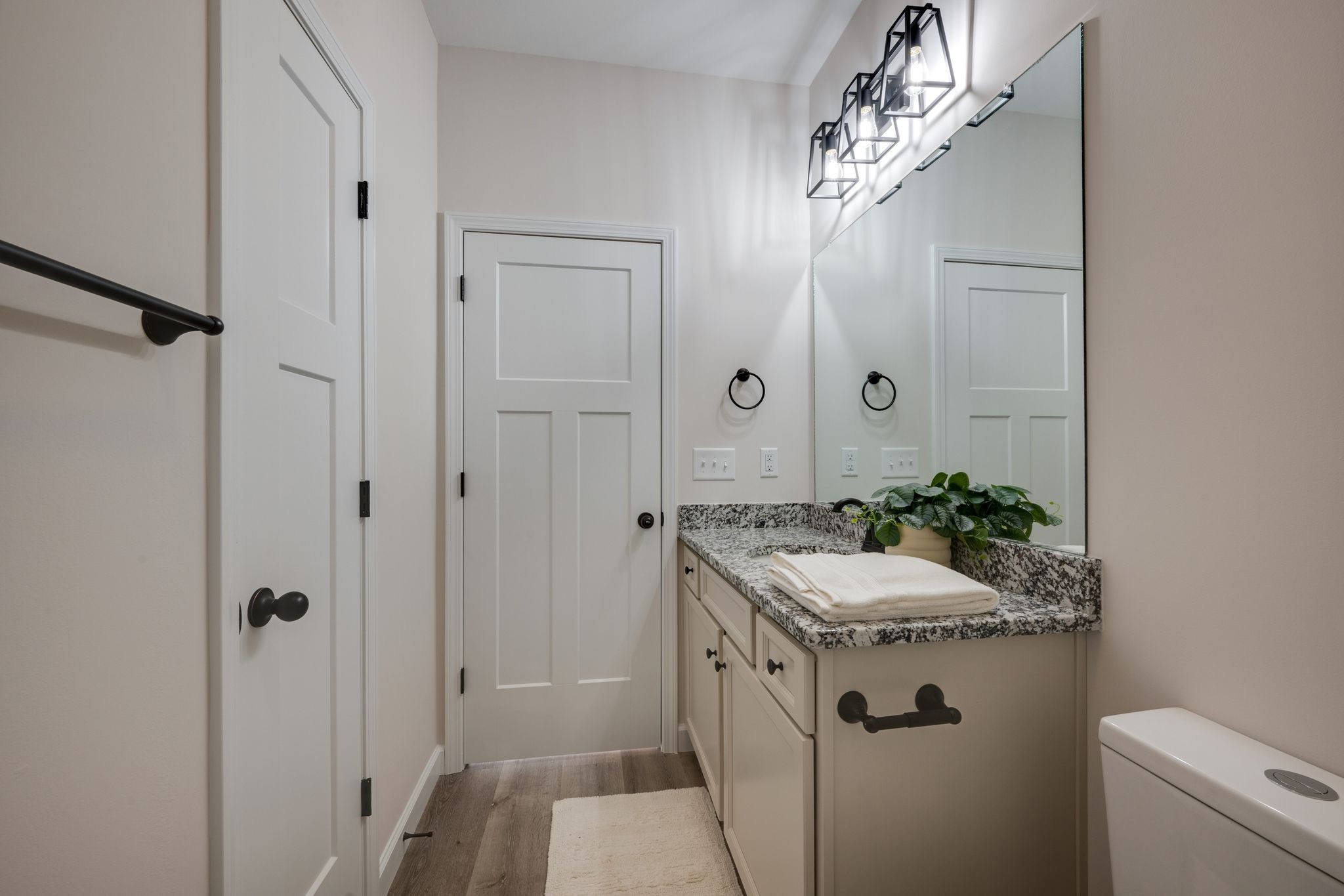 3033 Bowker Road Charlotte, TN 37036 - Photo 25 of 30 a bathroom with a granite countertop sink a mirror and a shower
