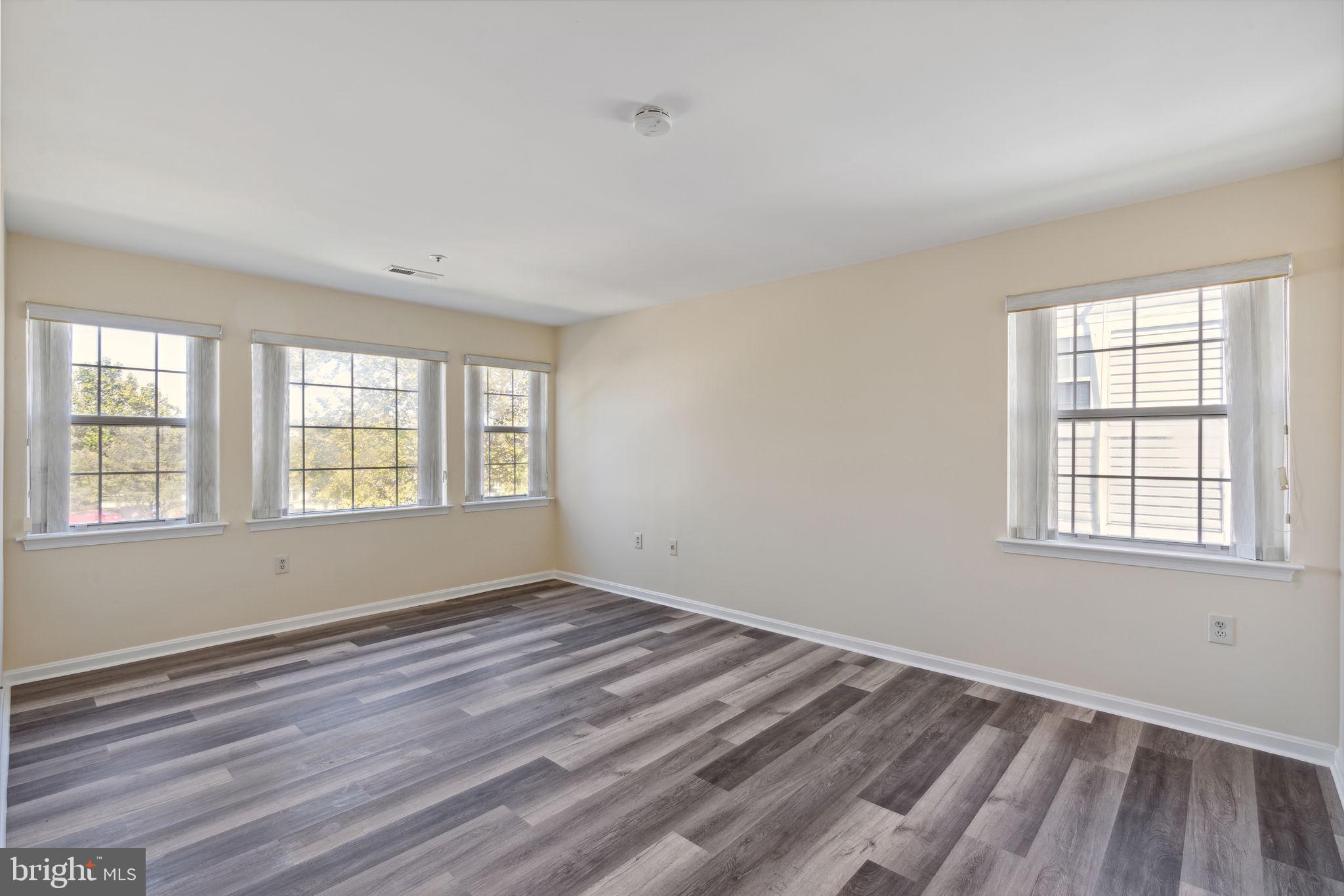 8381 Montgomery Run Road, Unit E Ellicott City, MD 21043 - Photo 17 of 31 Bright primary bedroom with windows on two walls