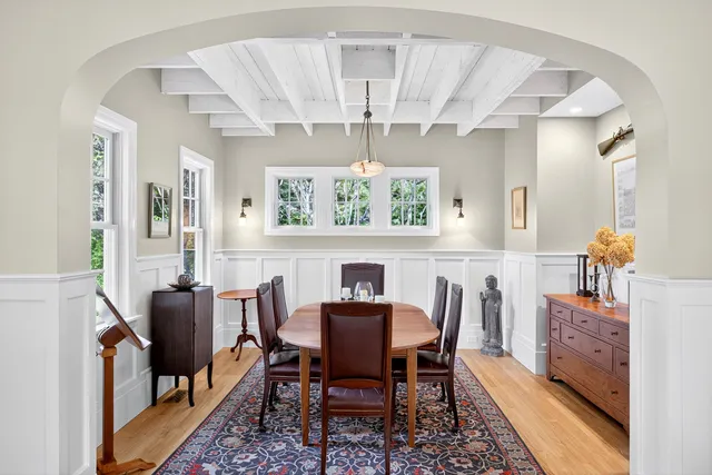 a view of a dining room with furniture and chandelier