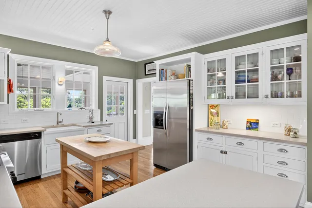 a kitchen with a refrigerator a sink and cabinets