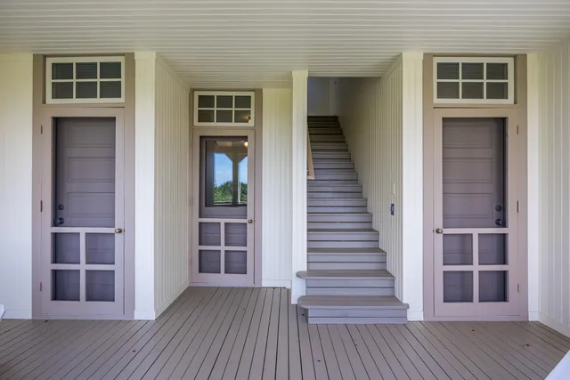 an entryway with wooden floor and stairs
