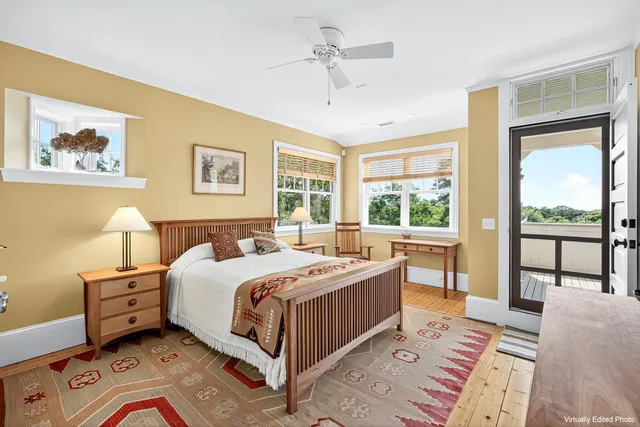 a bedroom with a bed lamp and a large window