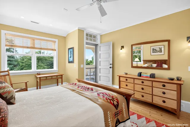 a bedroom with a bed and a dresser next to a window