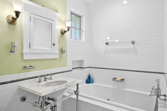 a bathroom with a bathtub and a sink
