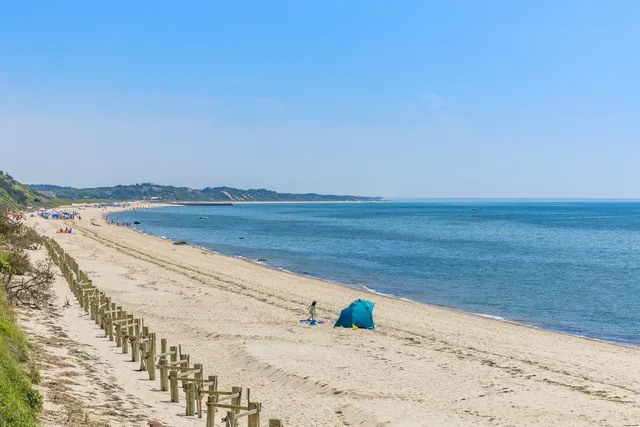 a front view of a house with a yard table and chairs