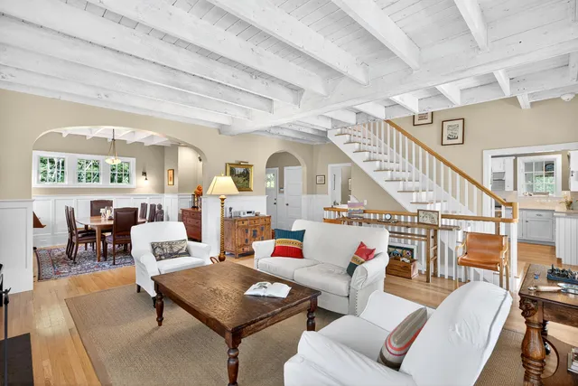 a living room with furniture a table and chairs