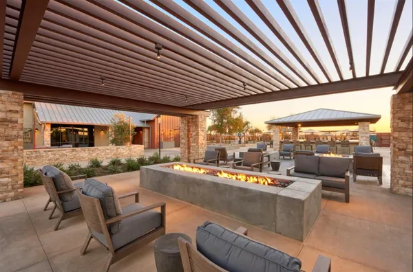 a living room with fireplace furniture and a large window