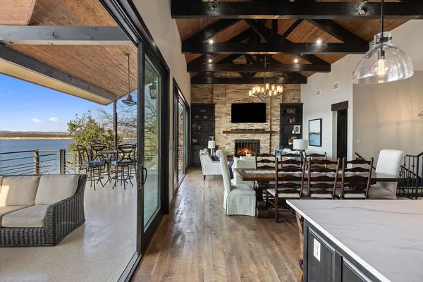 a view of a dining room with furniture wooden floor and chandelier