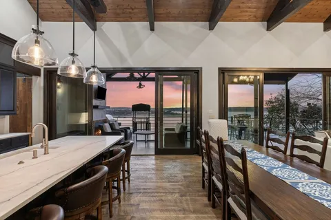 a dining table with chairs and window