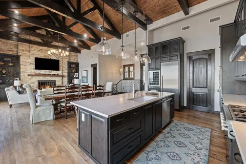 a large kitchen with a table and chairs