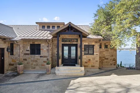 a view of a brick house with large windows