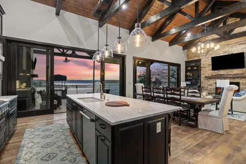a kitchen with a stove a counter space a sink and chairs