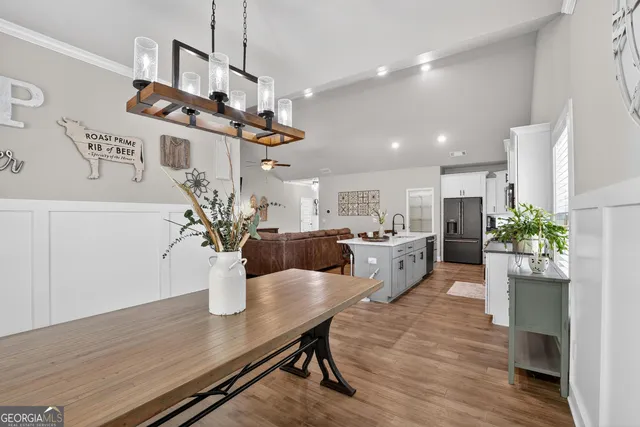 a living room with kitchen island furniture and a chandelier