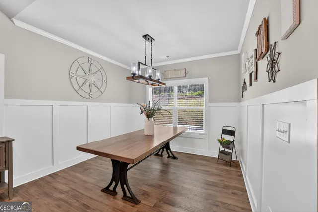 a view of a room with furniture and wooden floor