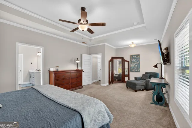 a bedroom with a bed and ceiling fan