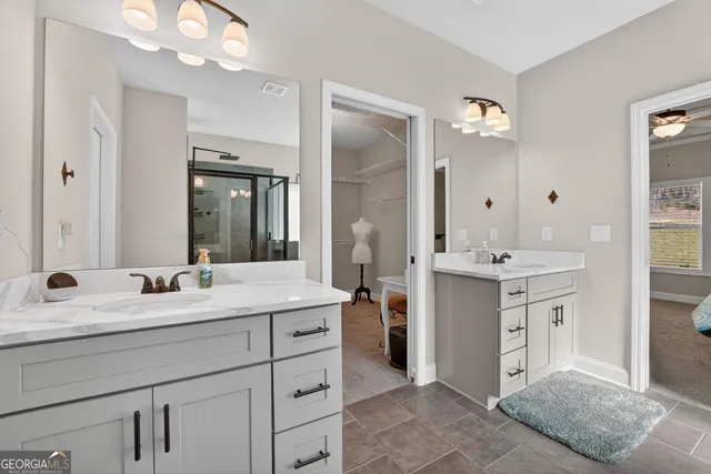 a bathroom with a sink vanity and mirror