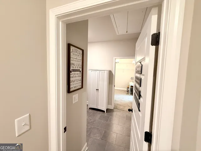 a view of a hallway with windows and entryway