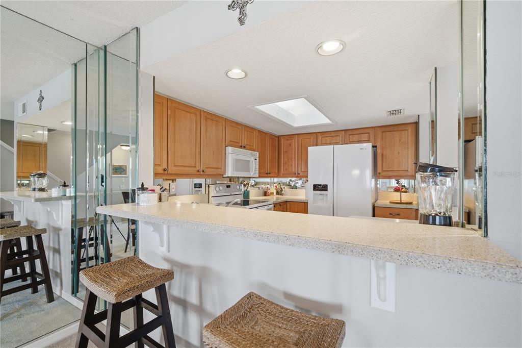 643 Garland Circle Indian Rocks Beach, FL 33785 - Photo 20 of 81 a large kitchen with lots of counter space and chairs