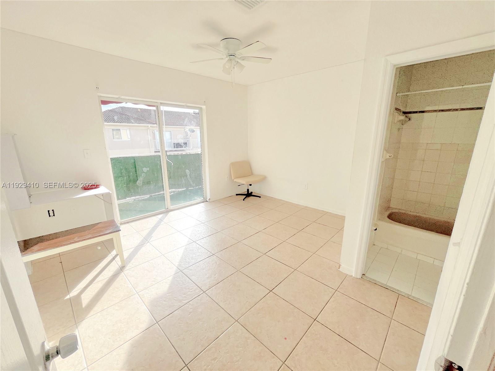 220 East 4th Street, Unit 3 Hialeah, FL 33010 - Photo 12 of 22 a view of empty room with wooden floor and fan