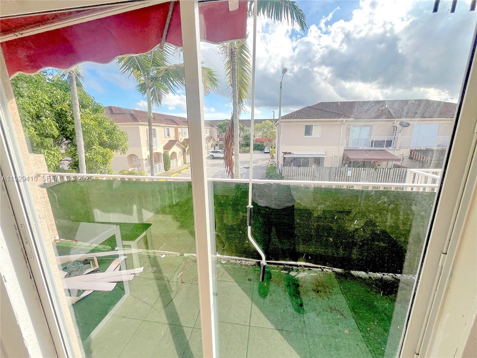 220 East 4th Street, Unit 3 Hialeah, FL 33010 - Photo 15 of 22 a view of swimming pool from a window