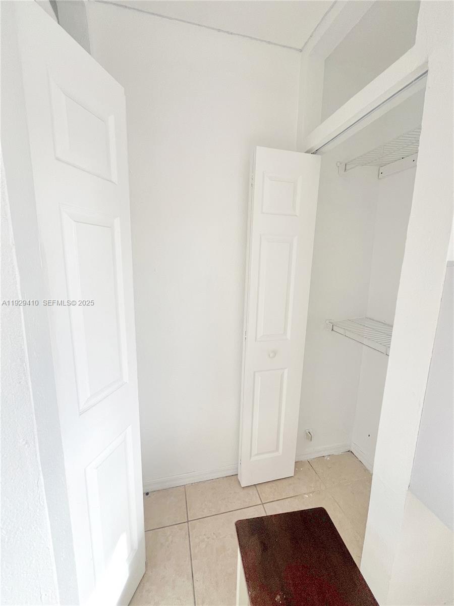220 East 4th Street, Unit 3 Hialeah, FL 33010 - Photo 16 of 22 a view of walk in closet with wooden floor