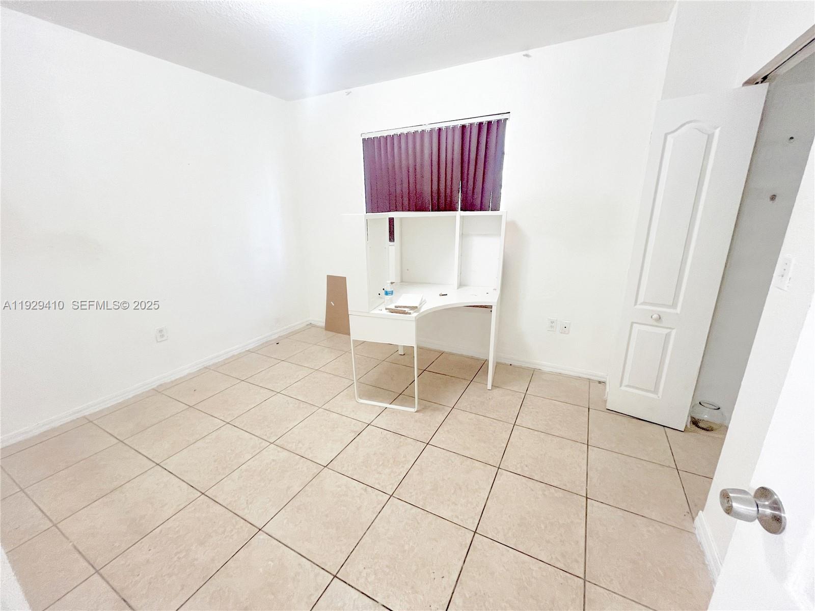 220 East 4th Street, Unit 3 Hialeah, FL 33010 - Photo 18 of 22 a living room with a rug