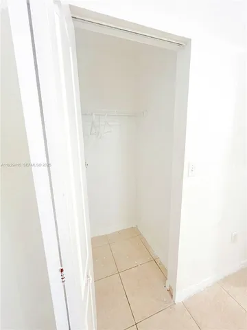 a view of a floor to a window with a tree in front of it