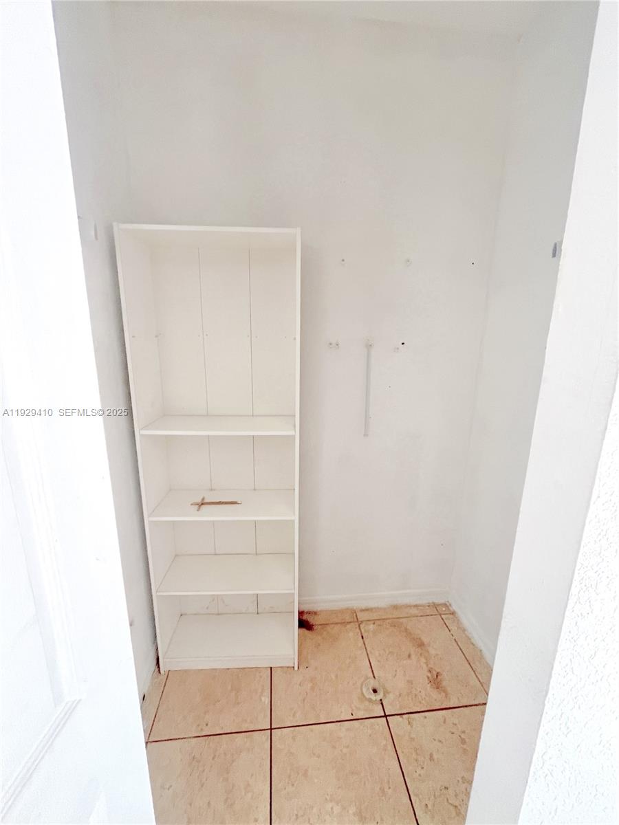 220 East 4th Street, Unit 3 Hialeah, FL 33010 - Photo 6 of 22 a view of walk in closet with empty racks