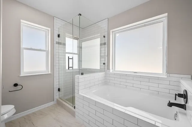 a bathroom with a bathtub and a shower