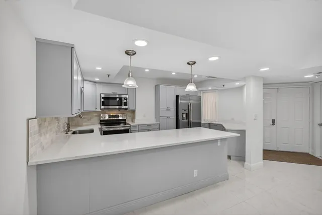 a view of a kitchen with a sink stainless steel appliances and cabinets