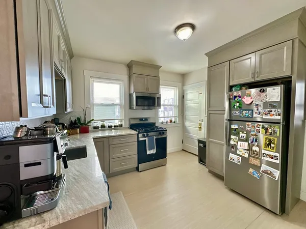 a kitchen with a stove a sink and a refrigerator