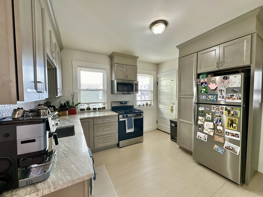 a kitchen with a stove a sink and a refrigerator