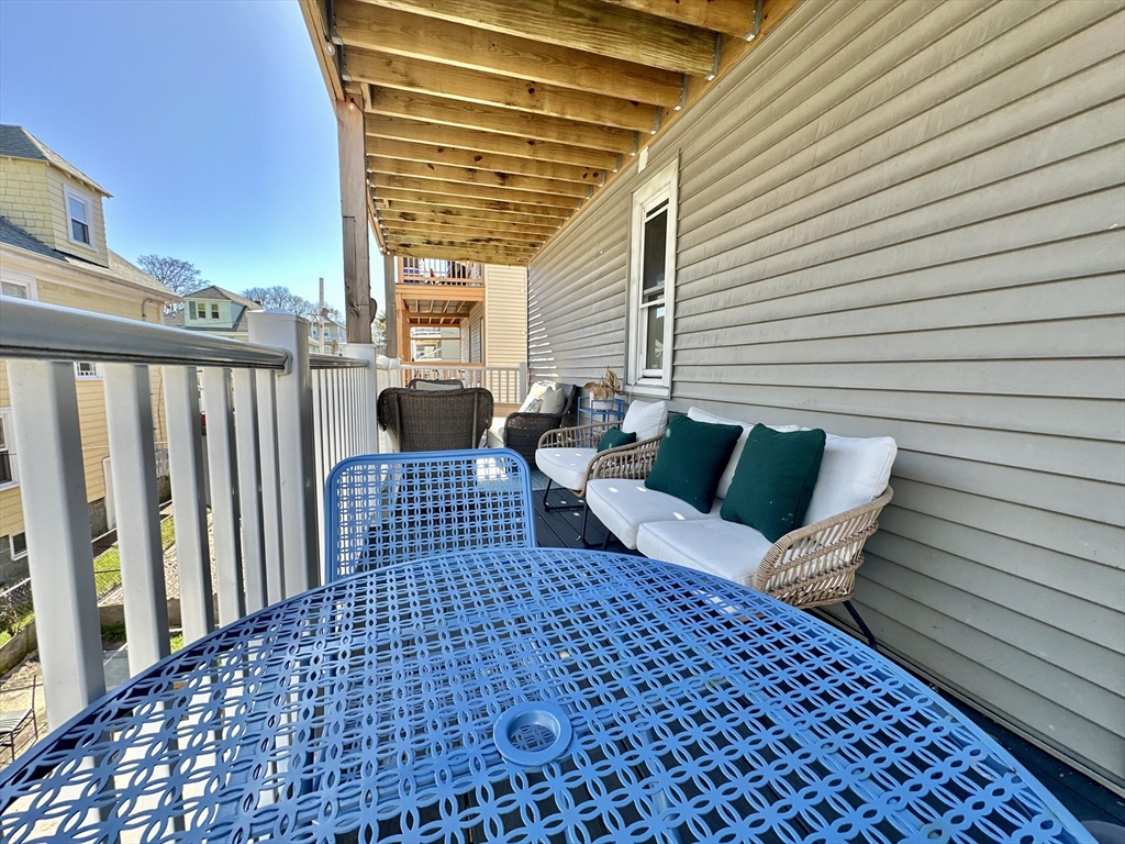 369 Centre Street, Unit 2 Boston, MA 02122 - Photo 14 of 16 a view of a patio with a table and chairs