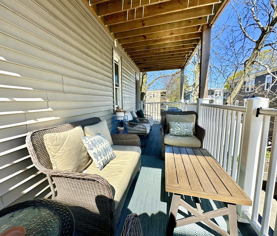 369 Centre Street, Unit 2 Boston, MA 02122 - Photo 15 of 16 a view of a patio with couches chairs and wooden floor