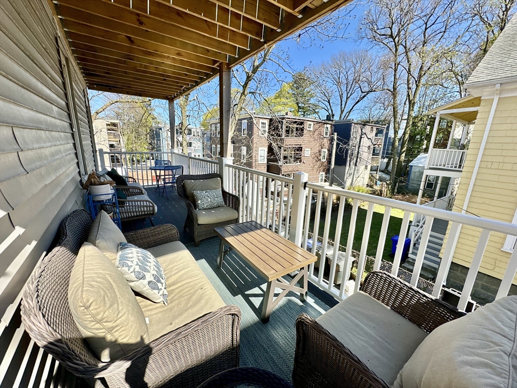 369 Centre Street, Unit 2 Boston, MA 02122 - Photo 16 of 16 a view of a patio with a table chairs and a potted plant