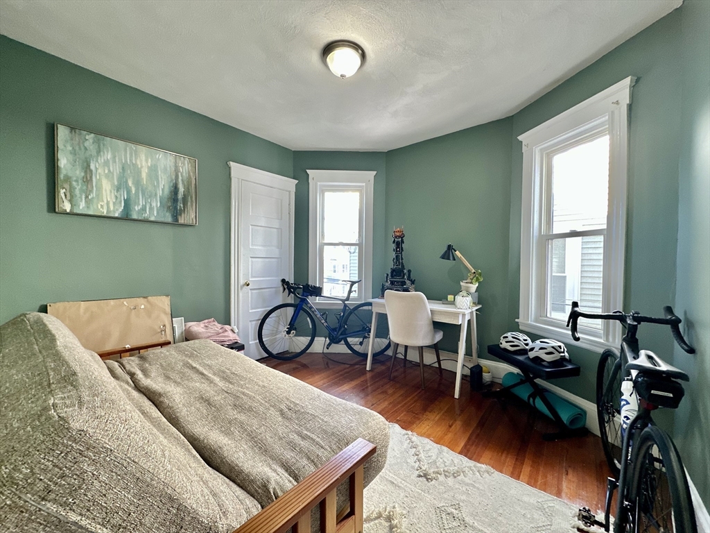 369 Centre Street, Unit 2 Boston, MA 02122 - Photo 5 of 16 a bedroom with furniture and a wooden floor