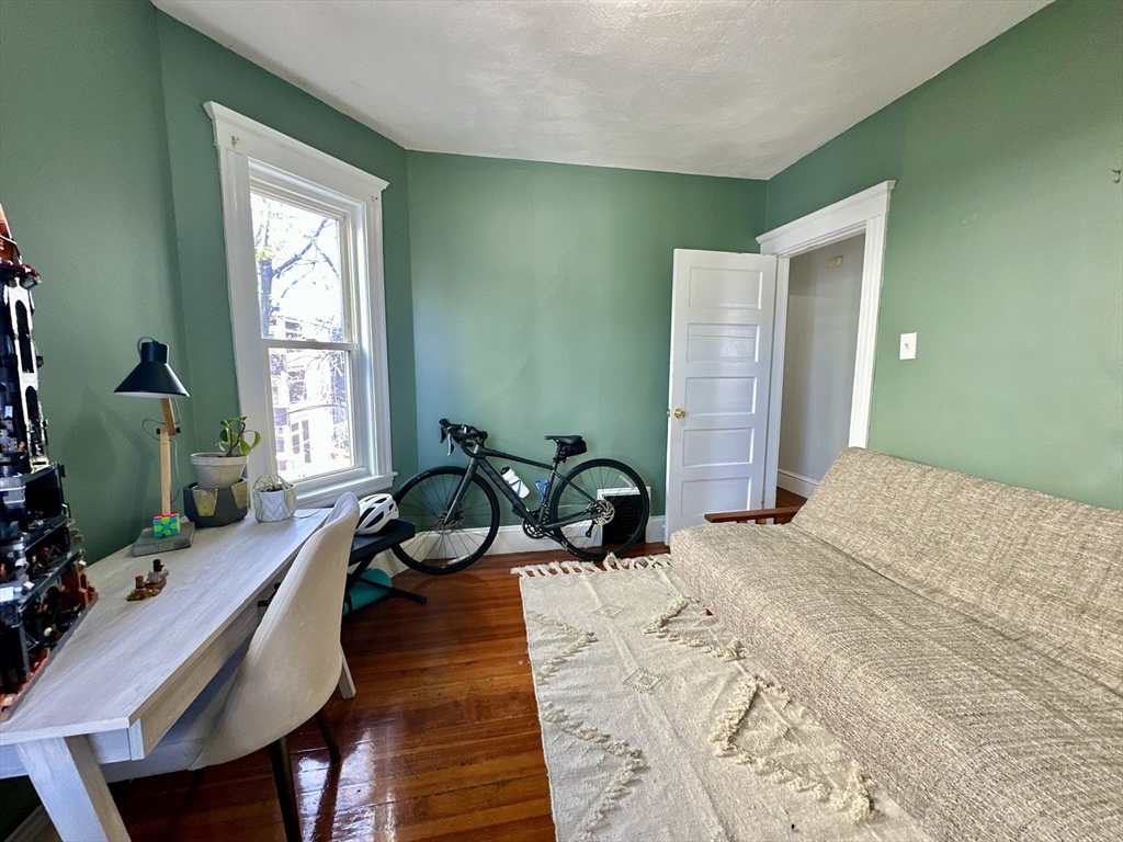 369 Centre Street, Unit 2 Boston, MA 02122 - Photo 6 of 16 a bedroom with a bed and large windows