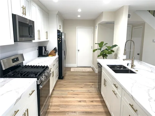 a kitchen with a sink stove and refrigerator