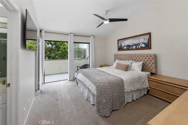 a bedroom with a bed and a painting on the wall