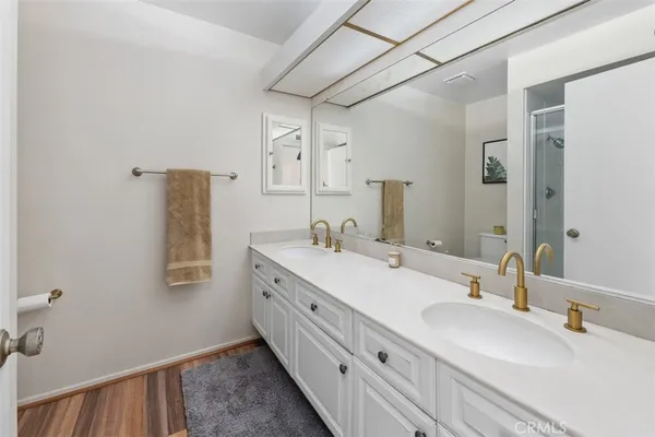 a bathroom with a double vanity sink and mirror