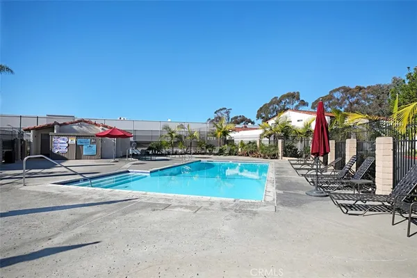 a view of a swimming pool with sitting area and furniture