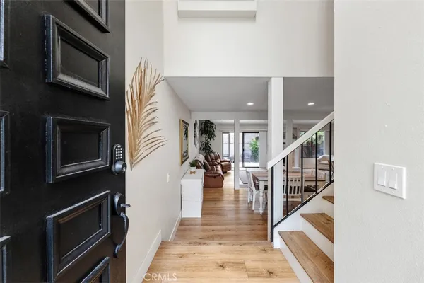 a view of a hallway with wooden floor and staircase
