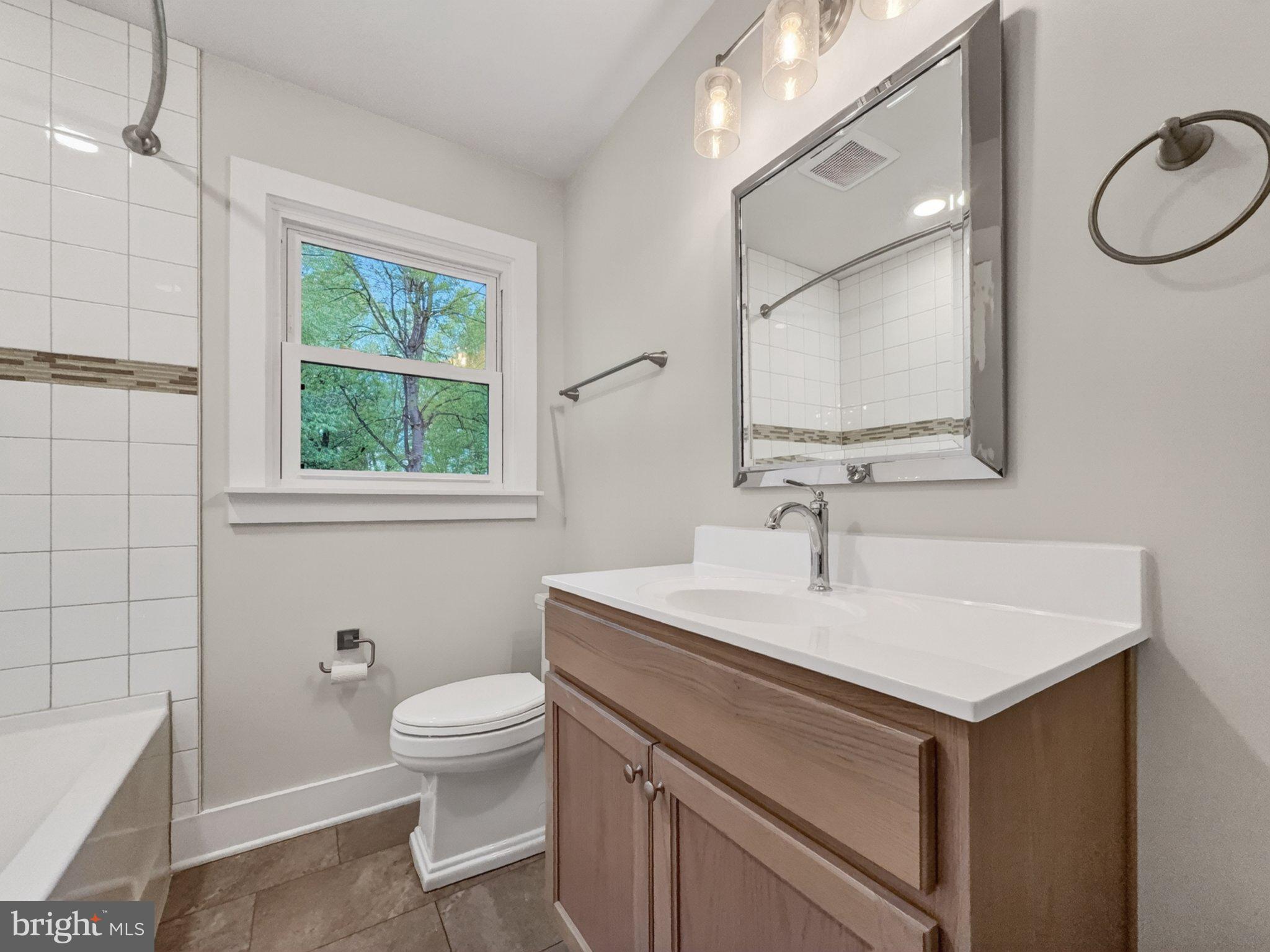 5408 Towles Mill Road Partlow, VA 22534 - Photo 21 of 24 a bathroom with a sink toilet a mirror and vanity