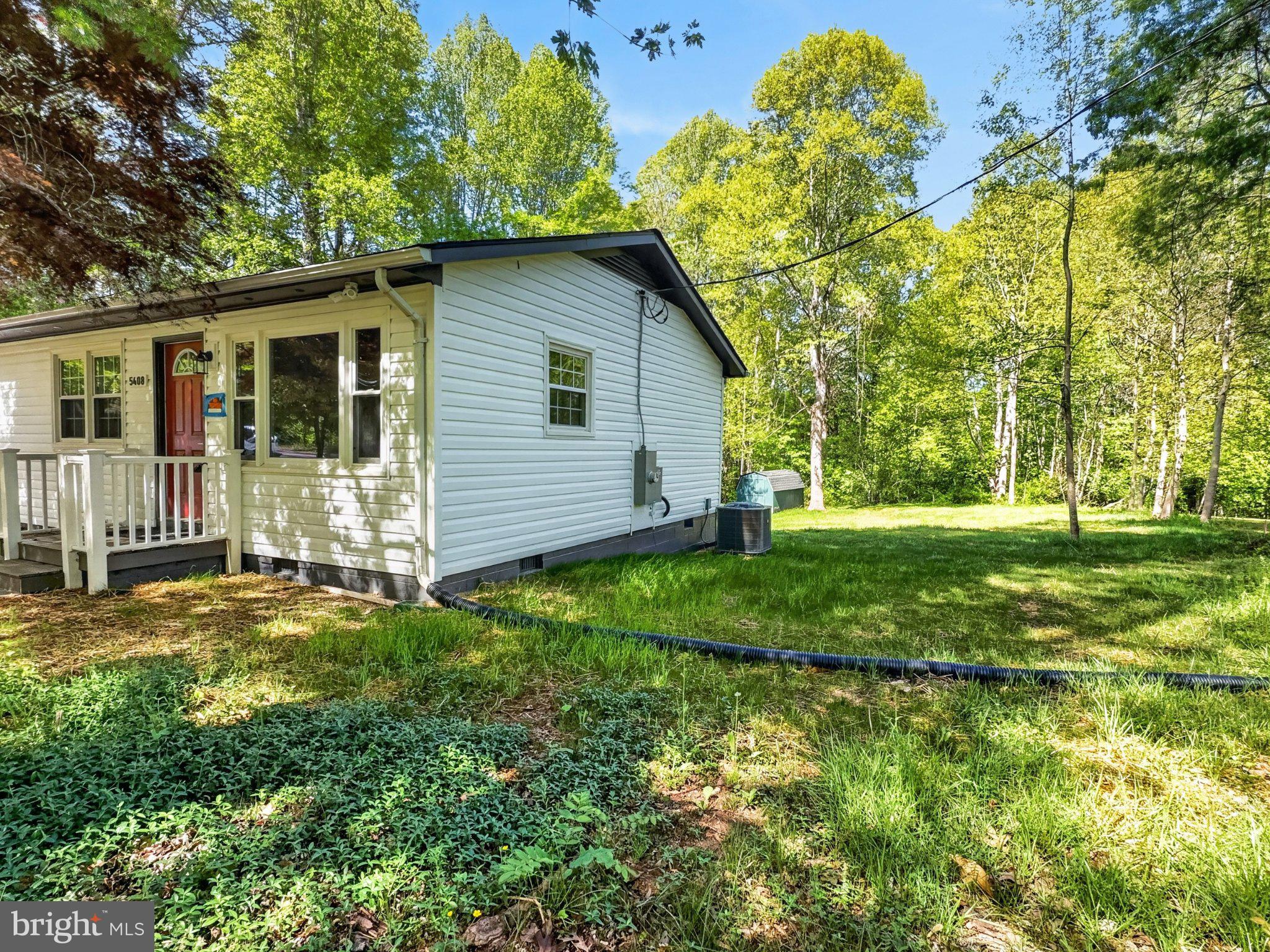 5408 Towles Mill Road Partlow, VA 22534 - Photo 5 of 24 a view of a house with yard and a garden