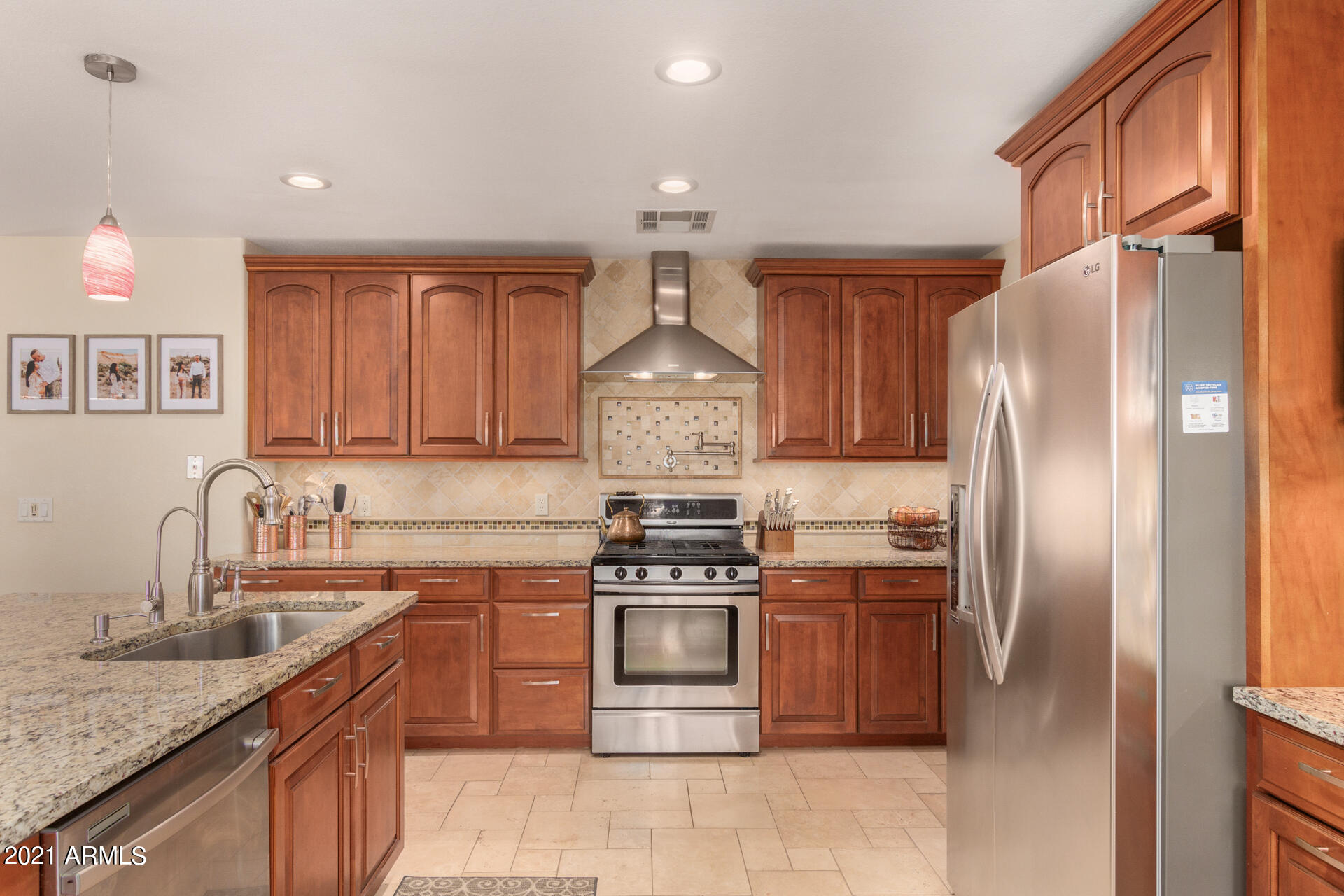 1250 South Palm Street Gilbert, AZ 85296 - Photo 11 of 45 a kitchen with stainless steel appliances granite countertop a sink stove and refrigerator