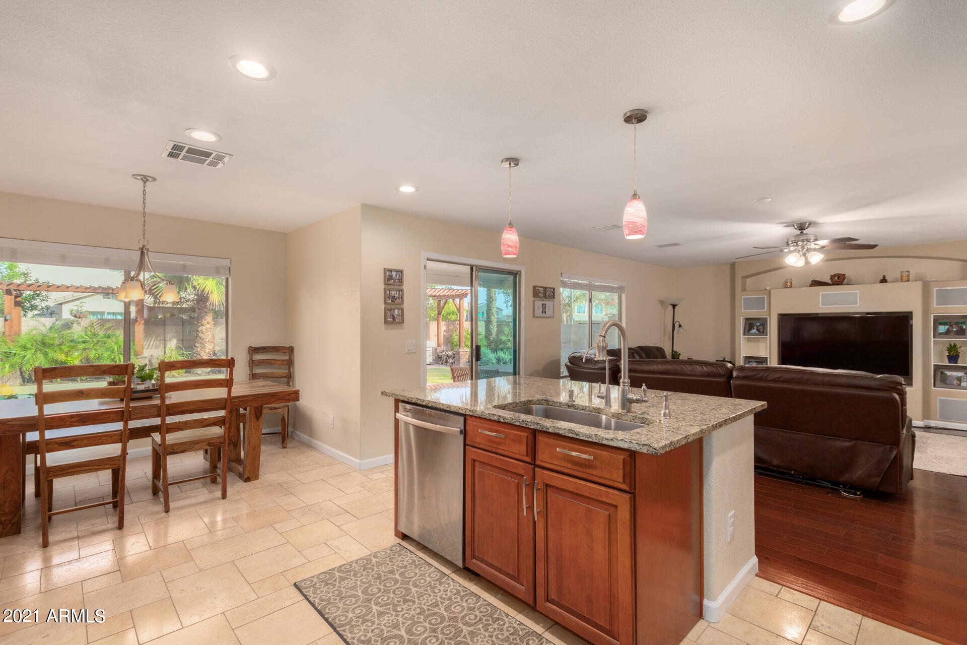 1250 South Palm Street Gilbert, AZ 85296 - Photo 12 of 45 a kitchen with a sink a counter top space and living room view